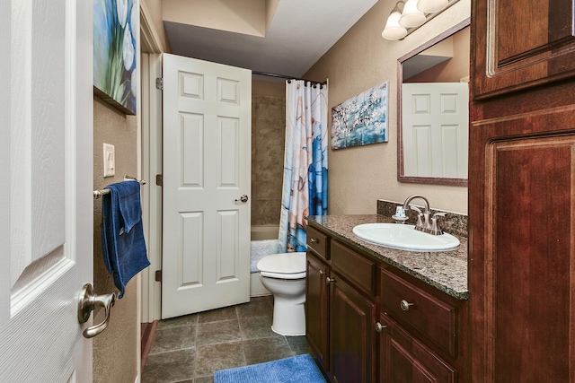 bathroom featuring toilet, shower / bath combination with curtain, vanity, and a textured wall