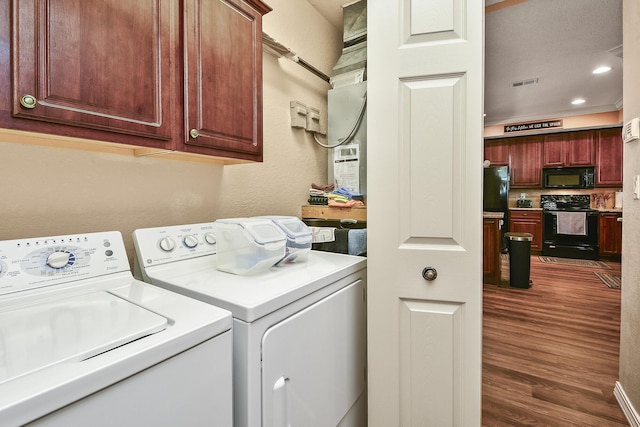 laundry room featuring visible vents, recessed lighting, dark wood-style floors, cabinet space, and separate washer and dryer