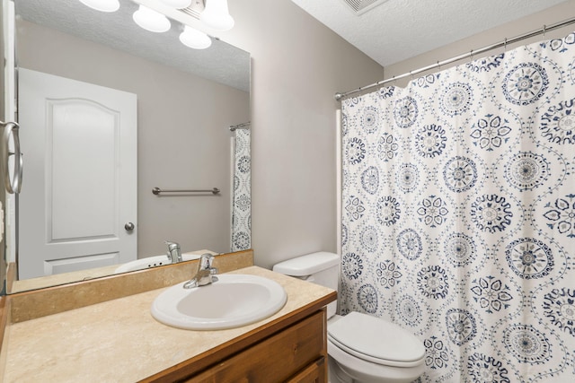 full bathroom with vanity, curtained shower, toilet, and a textured ceiling