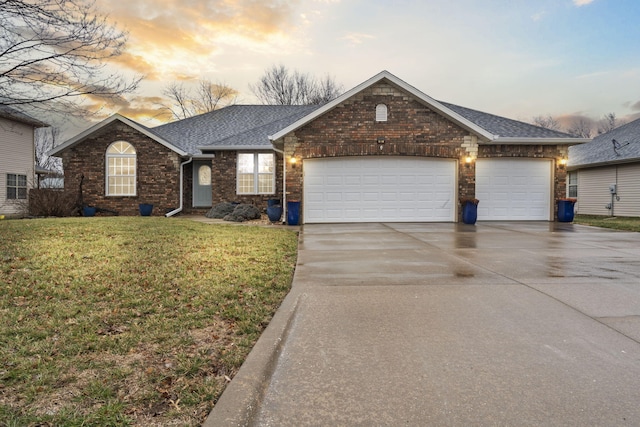 single story home featuring a front lawn, roof with shingles, concrete driveway, a garage, and brick siding