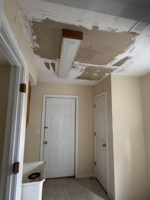 hall with light tile patterned flooring