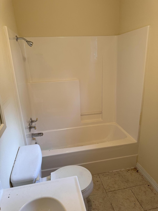 bathroom with tile patterned flooring, toilet, shower / tub combination, and baseboards