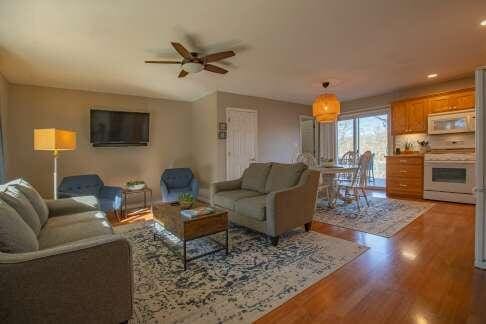 living room featuring ceiling fan and wood finished floors