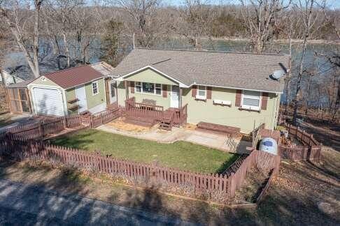 ranch-style house with a front lawn and a fenced backyard