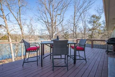 wooden deck featuring outdoor dining space and a grill