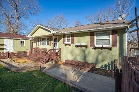 view of front of property with a patio and fence