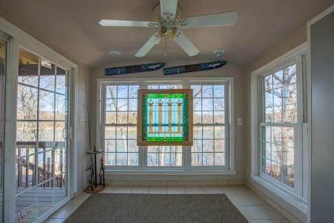 unfurnished sunroom featuring lofted ceiling and ceiling fan