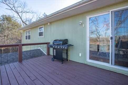 wooden terrace with a grill