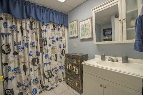 bathroom with tile patterned floors, curtained shower, vanity, and a paneled ceiling