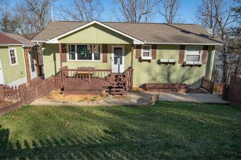 rear view of house featuring a yard