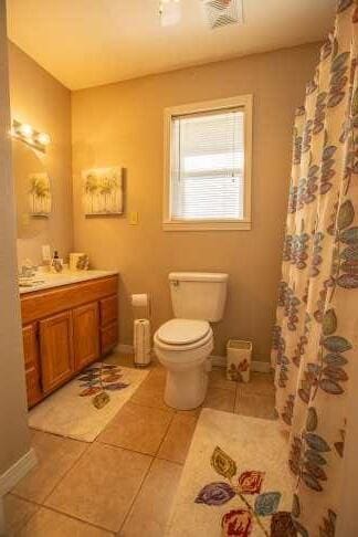 full bathroom with tile patterned flooring, visible vents, baseboards, toilet, and vanity