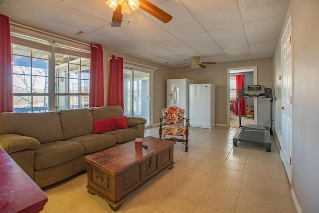 28007 Fox Fire Ln, Shell Knob, MO 65747 - living room featuring a ceiling fan, a drop ceiling, baseboards, and light tile patterned floors