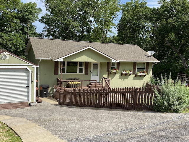 28007 Fox Fire Ln, Shell Knob, MO 65747 - view of front facade with a fenced front yard, an outbuilding, and roof with shingles