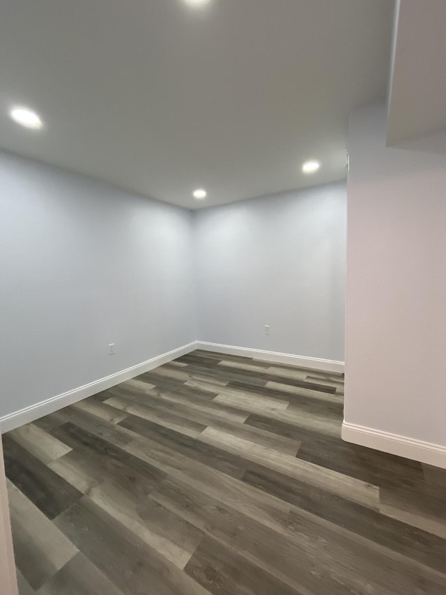 unfurnished room with dark wood-style floors, recessed lighting, and baseboards