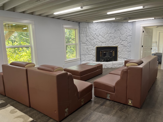 living room featuring beamed ceiling and wood finished floors