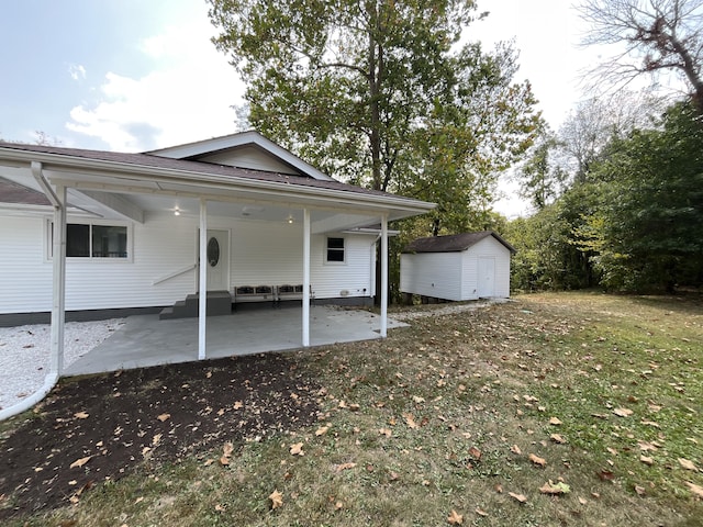 rear view of property featuring a shed, entry steps, an outdoor structure, and a patio