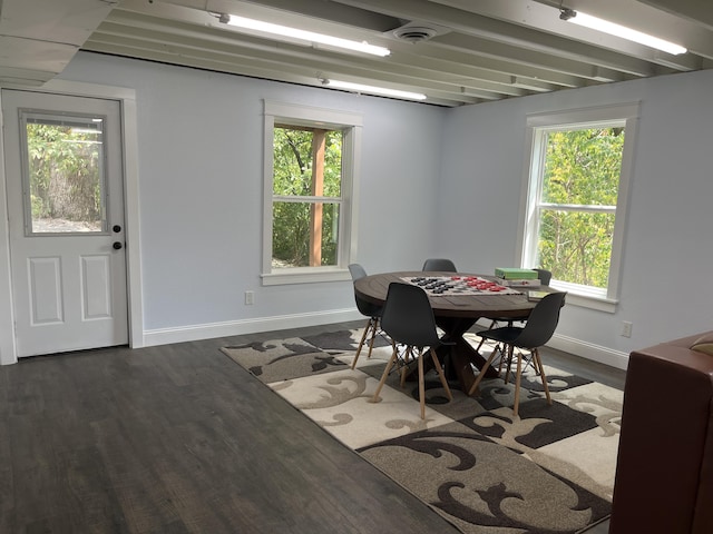 dining area with visible vents, dark wood-type flooring, and baseboards