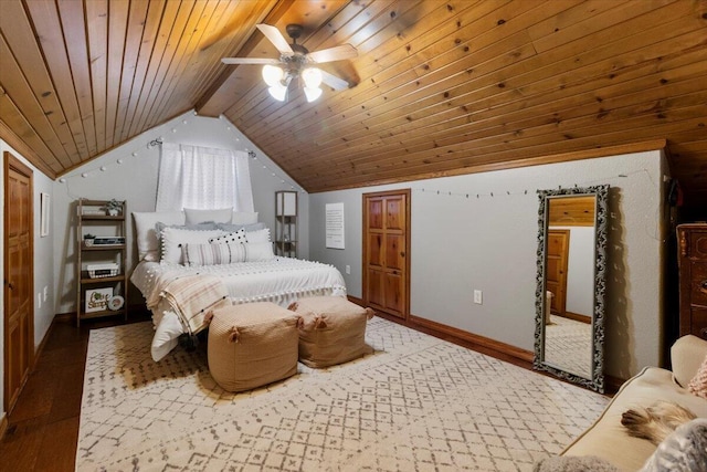 bedroom featuring a ceiling fan, lofted ceiling with beams, wood finished floors, baseboards, and wood ceiling