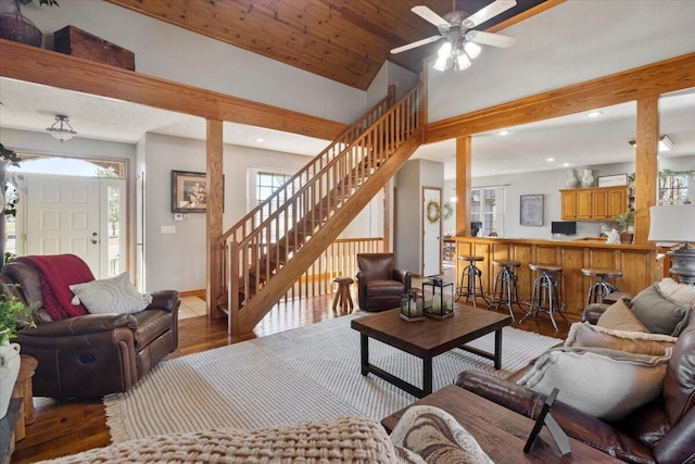 living area with wood finished floors, recessed lighting, stairway, baseboards, and ceiling fan