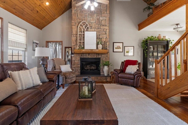 living room featuring stairs, wood finished floors, wood ceiling, and a fireplace