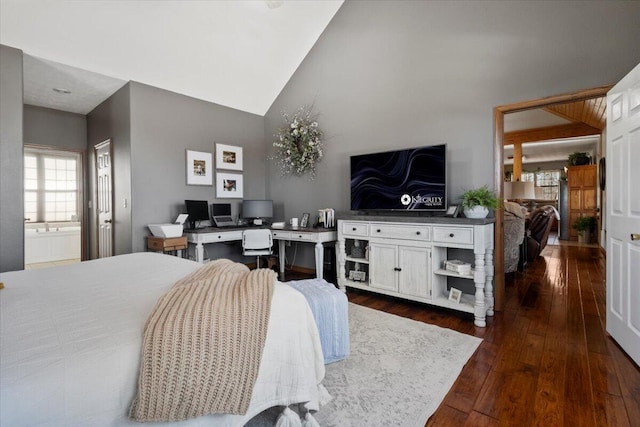 bedroom with dark wood finished floors and high vaulted ceiling