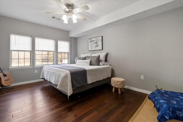 bedroom with visible vents, baseboards, dark wood-type flooring, and a ceiling fan