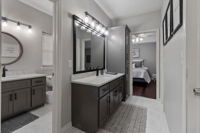 full bathroom with a sink, two vanities, and ceiling fan