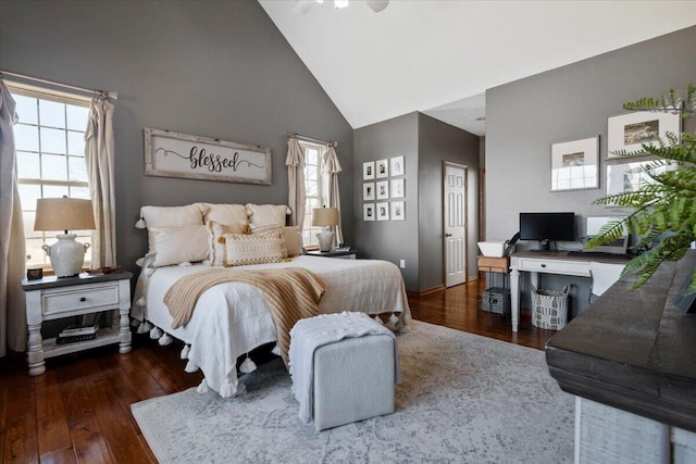 bedroom featuring high vaulted ceiling and wood finished floors