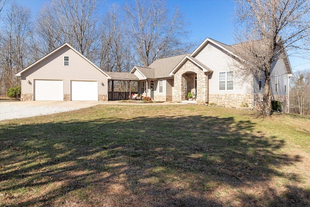 single story home with stone siding, driveway, an attached garage, and a front lawn