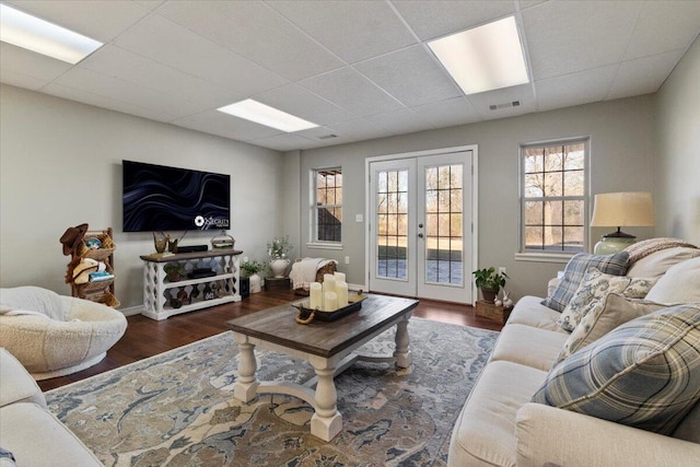 living room featuring french doors, a paneled ceiling, visible vents, and wood finished floors