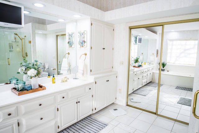 bathroom featuring vanity, tile patterned flooring, a shower stall, toilet, and a washtub