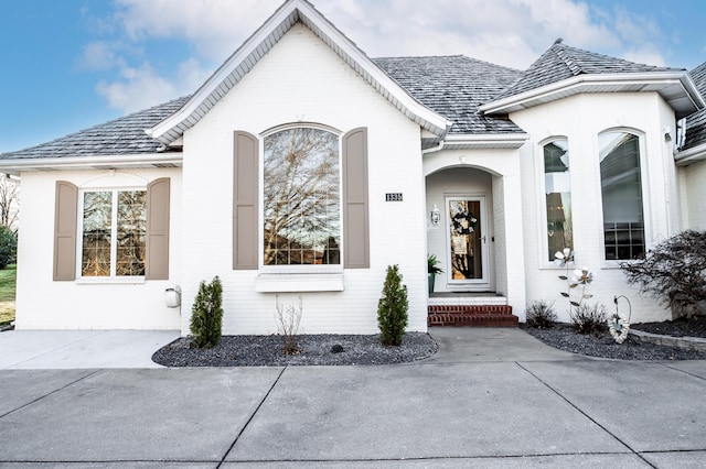 view of exterior entry featuring brick siding