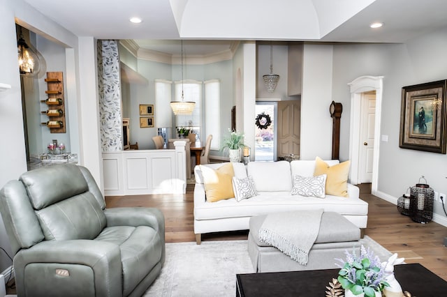 living room featuring recessed lighting, wood finished floors, baseboards, and ornamental molding