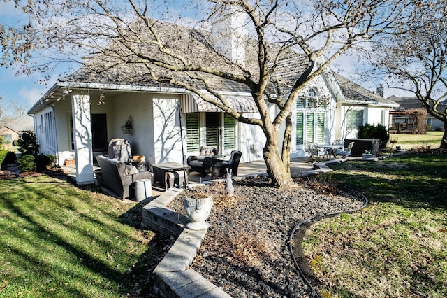 exterior space with an outdoor living space, a patio area, and a front lawn