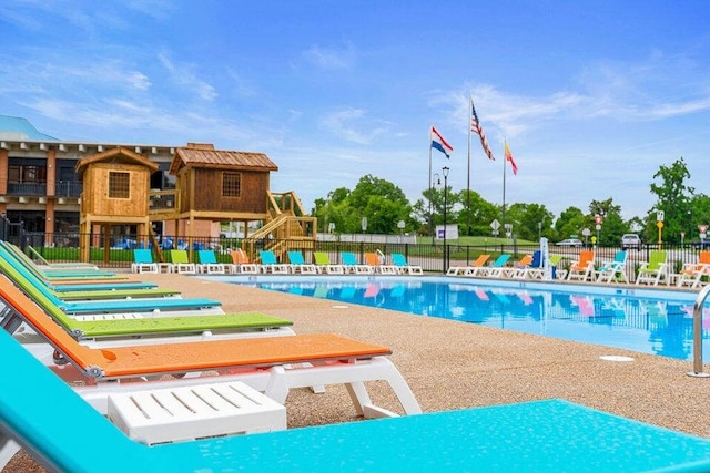 community pool featuring a patio area and fence