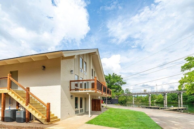 exterior space featuring stairway and central AC