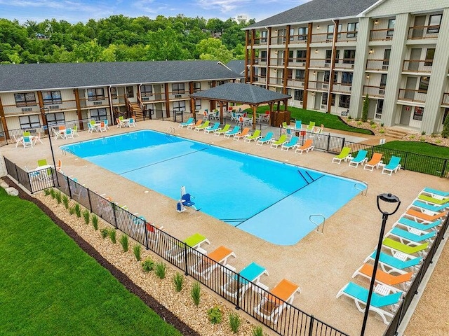 pool featuring a gazebo, a patio area, a yard, and fence