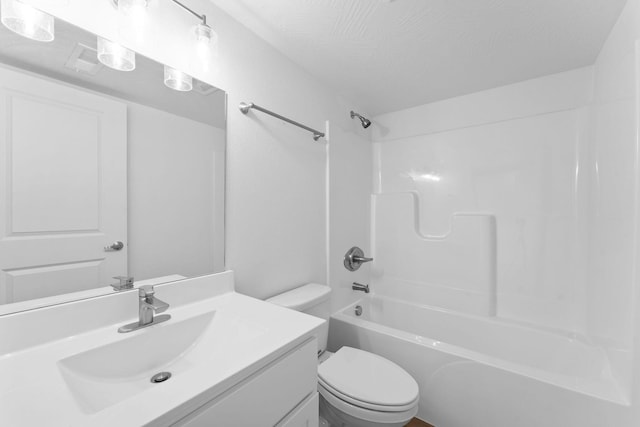 bathroom featuring toilet,  shower combination, vanity, and a textured ceiling