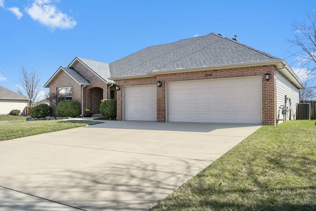 view of front of house with brick siding, concrete driveway, a garage, and roof with shingles