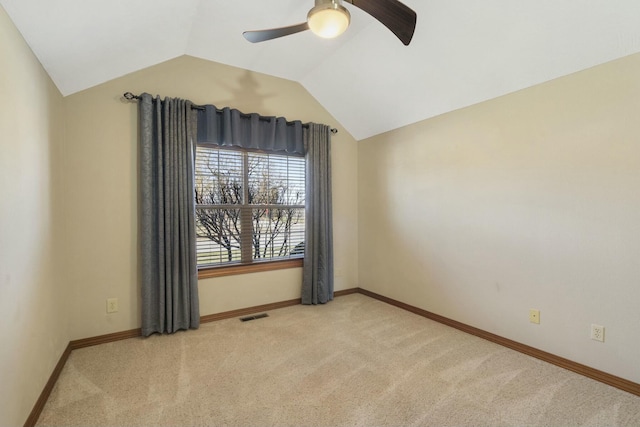 unfurnished room featuring a ceiling fan, visible vents, carpet floors, baseboards, and lofted ceiling