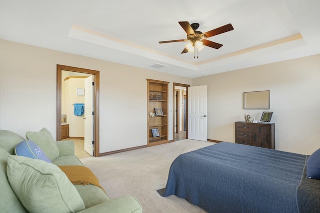 bedroom featuring visible vents, a raised ceiling, and baseboards