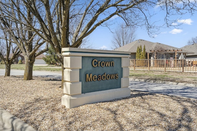 community sign featuring fence