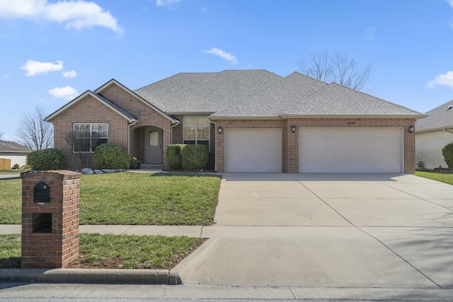 view of front of house with concrete driveway, a front lawn, a garage, and a shingled roof