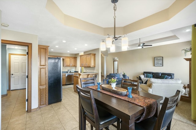 dining area with baseboards, ceiling fan, a tray ceiling, recessed lighting, and light tile patterned flooring