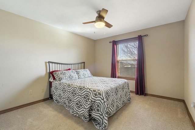 bedroom with light colored carpet, baseboards, and ceiling fan