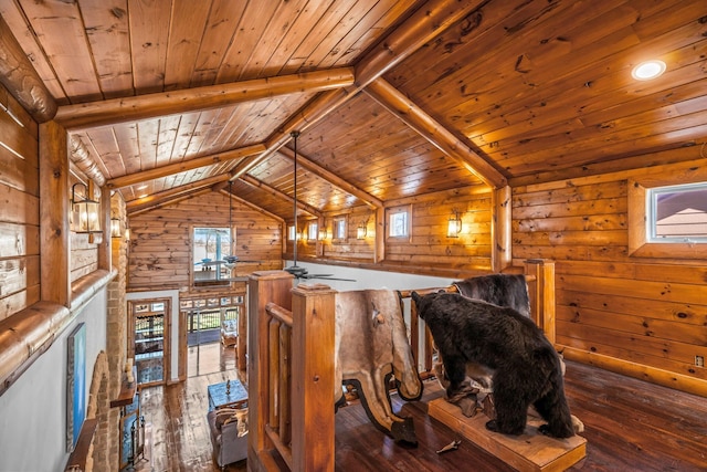 interior space with hardwood / wood-style flooring, vaulted ceiling with beams, an upstairs landing, and wooden ceiling