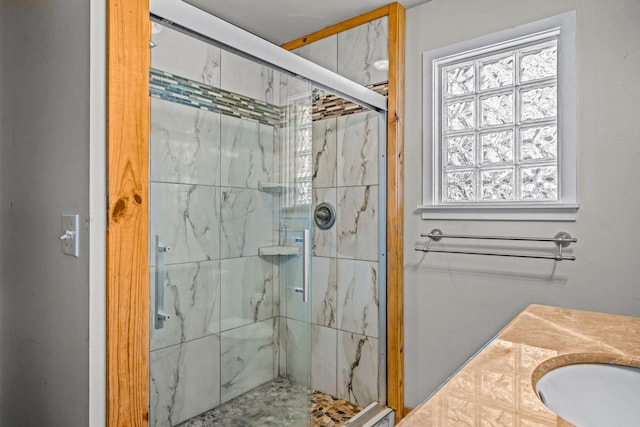 full bathroom featuring a marble finish shower and a sink