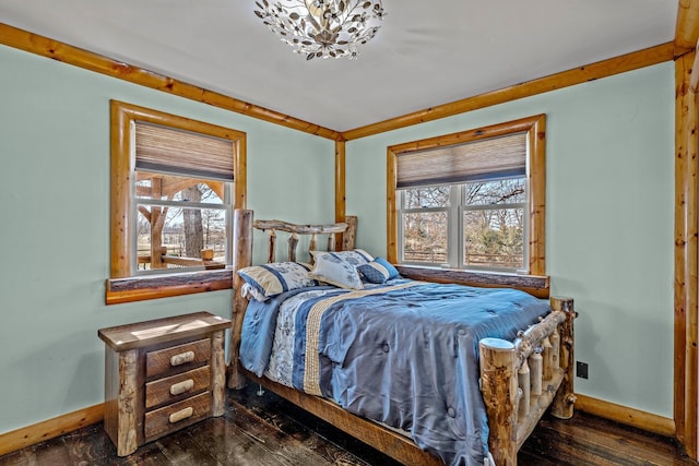 bedroom with baseboards, multiple windows, and dark wood-style flooring