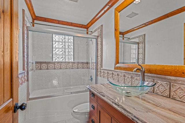 full bath featuring visible vents, bath / shower combo with glass door, vanity, and toilet