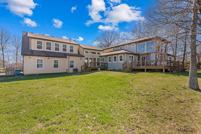 back of house with a wooden deck, a yard, central AC unit, and a shingled roof